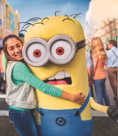 A girl hugs a Minion making a silly face at Universal Studios Florida.