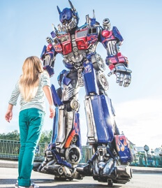 A girl looks up at Optimus Prime at Universal Studios Florida.